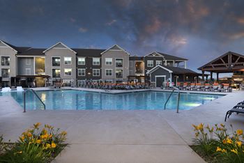 a swimming pool at night at an apartment complex  at Watermark at Harvest Junction, Colorado